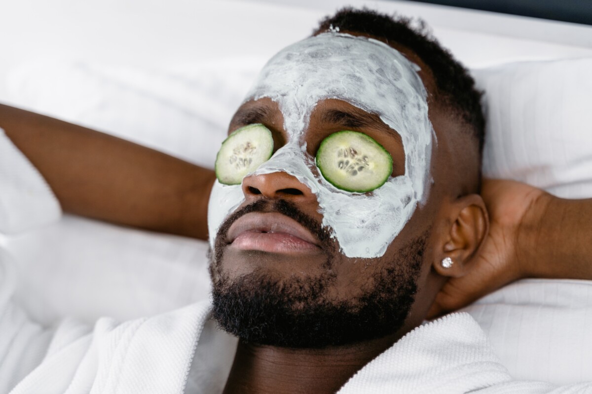 A man applying facial moisturizer as part of his modern skincare routine.